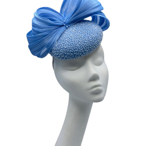 A beautiful blue beaded silk chiffon cocktail/percher hat, trimmed with luxurious silk abaca swirls and a splash of crystals and pearls.